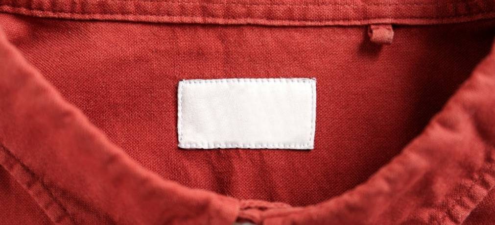 Blank clothing label on red shirt, top view